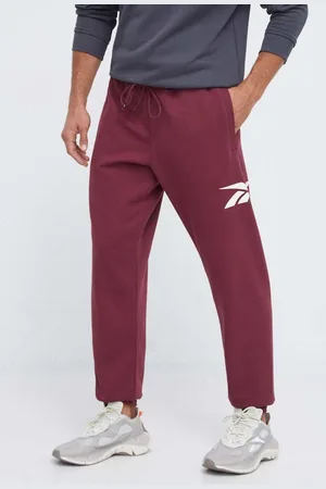 Reebok Tepláky vínová barva, s potiskem