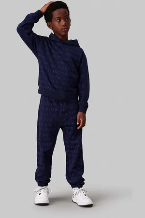 Calvin Klein Dětské bavlněné tepláky AOP JOGGER tmavomodrá barva, IB0IB02323