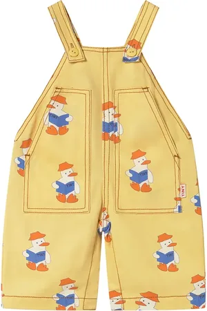 Tiny Cottons Dětské lacláče BABY READERS DUNGAREE barva, s potiskem, SS25-195