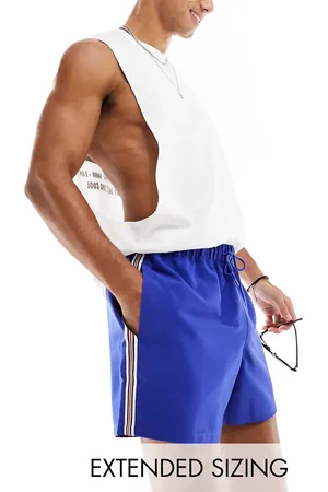 ASOS Swim shorts in short length with black and red side stripe