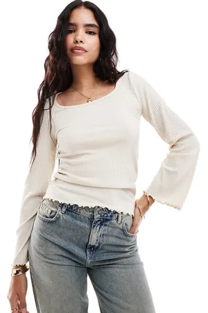 VILA Ribbed long sleeve scoop neck top with lettuce edge detail in cream