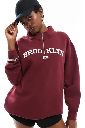 Daisy Street Quarter zip sweatshirt in burgundy with large collegiate graphic