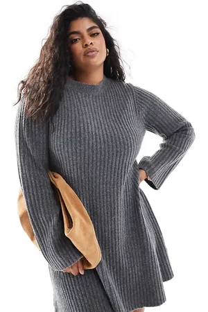 In The Style Knitted bell sleeve flippy mini dress with contrast bow back in charcoal