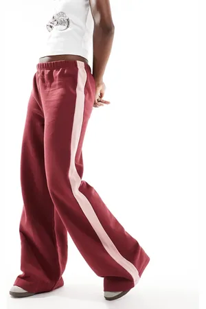 ASOS Oversized track pant with pink side stripe in burgundy