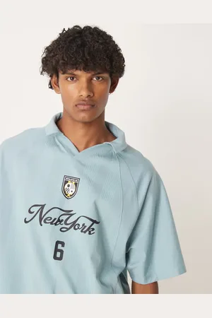 ASOS Boxy oversized polo with sports graphic in light