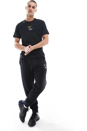 Nike Club Swoosh graphic joggers in and yellow