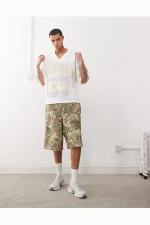 COLLUSION Skater relaxed jersey shorts in tree camo print