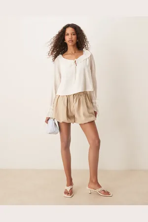 ASOS Tailored crinkle puffball hem shorts in stone
