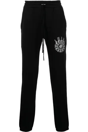 AMIRI Slim-cut logo-print track pants