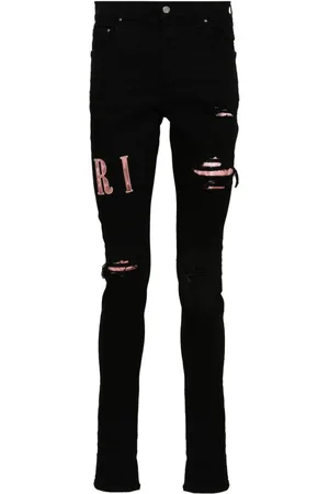 AMIRI Waxed logo-appliqué skinny jeans