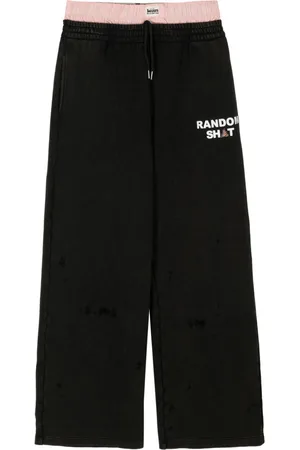 Natasha Zinko Layered logo-print trousers
