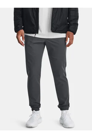 Under Armour Tmavě šedé sportovní tepláky UA Stretch Woven CW Jogger